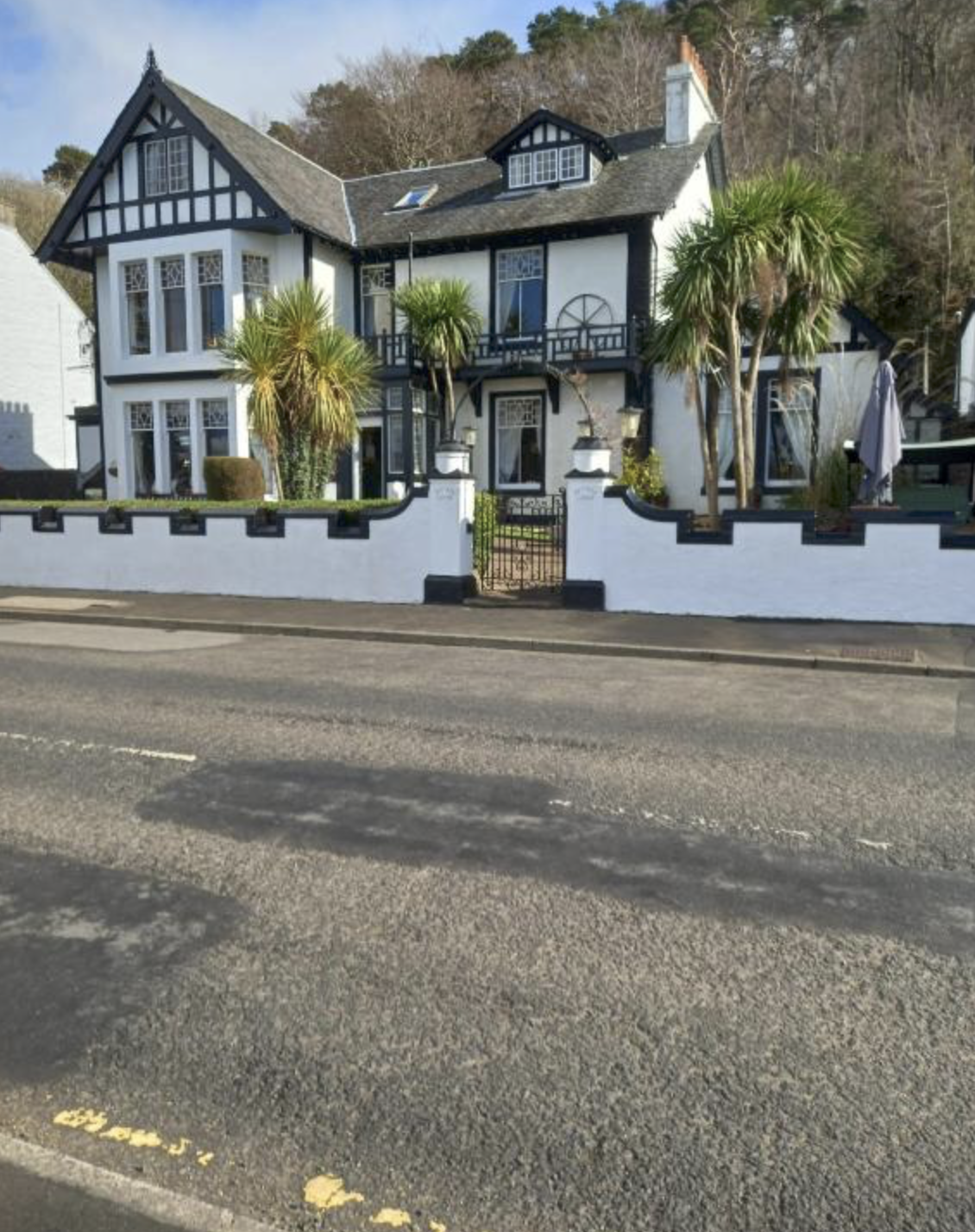 Battery Lodge, a black-and-white villa with palms on Rothesay's seafront