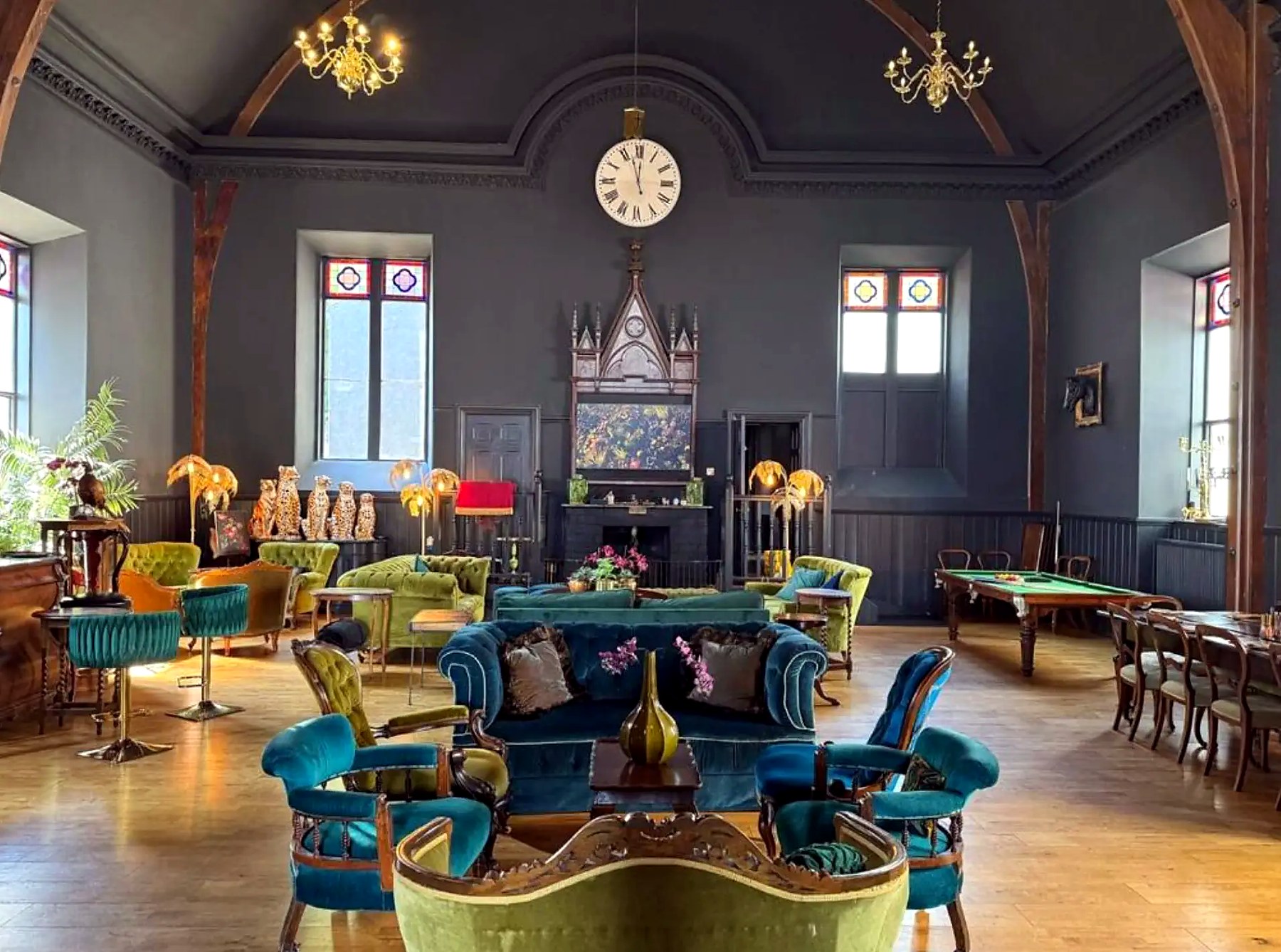Grand vaulted lounge with clock and velvet sofas at The Old Church, Isle of Bute