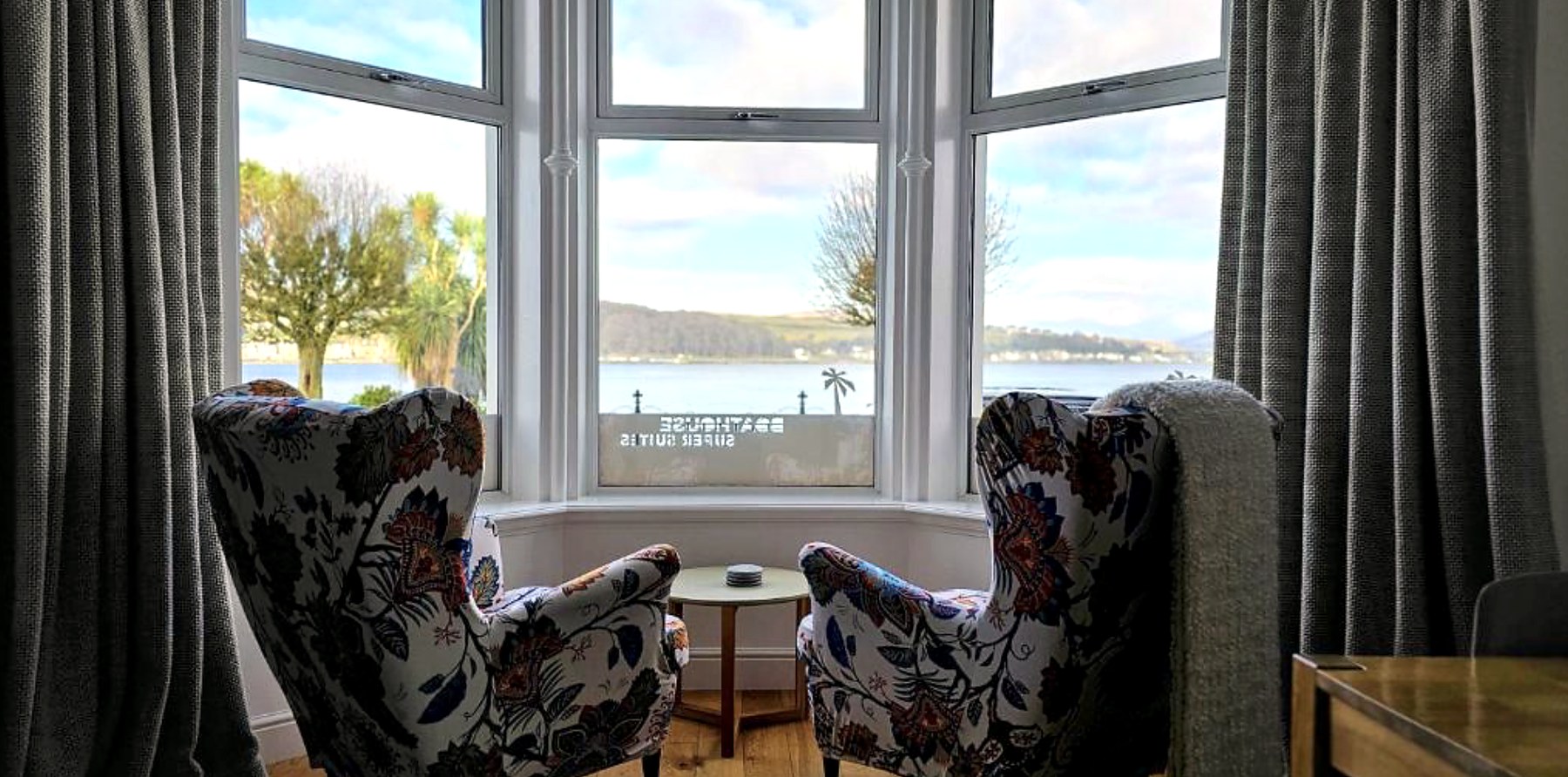 Armchairs in a bay window at Dairsie Seaview Flat looking over Rothesay Bay
