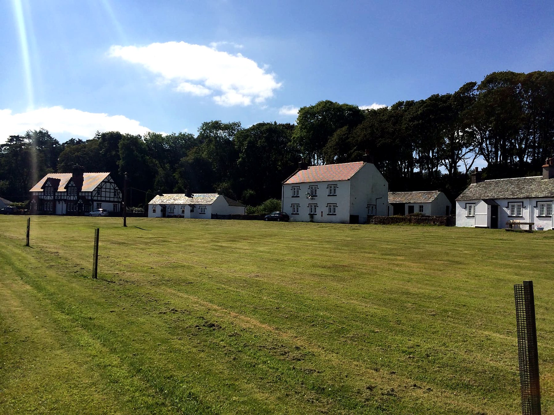 White cottages and a half-timbered house around the village green at Kerrycroy on the Mount Stuart estate, Isle of Bute